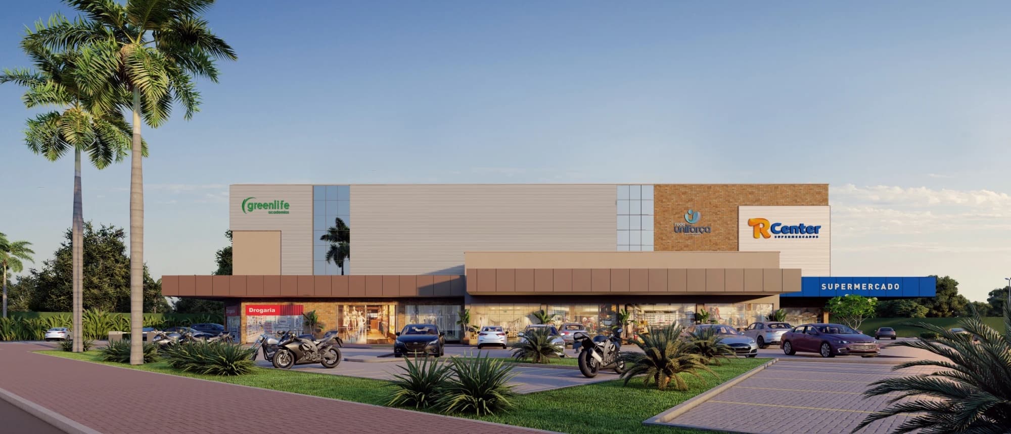 Fachada do Vita Park Mall ao entardecer, com R Center, Greenlife e drogaria, coqueiros e estacionamento na frente